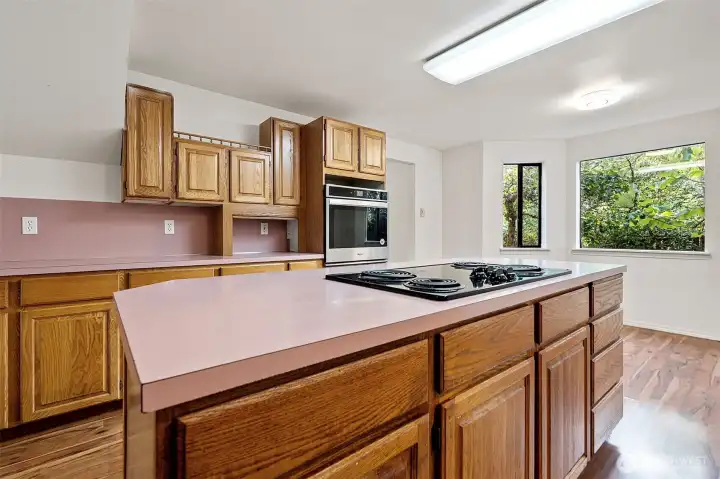 Kitchen has an island in the middle of it.