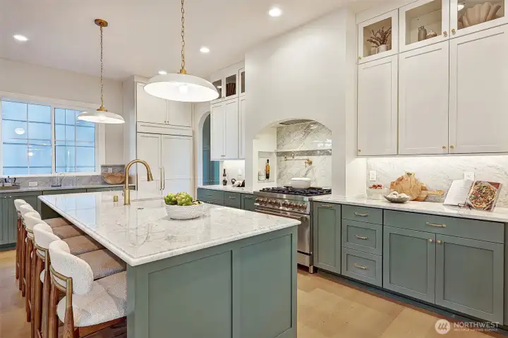 An entertainer's dream kitchen: outfitted with high-end appliances, marble countertops, a 9-foot island, pot filler, and abundant storage space.