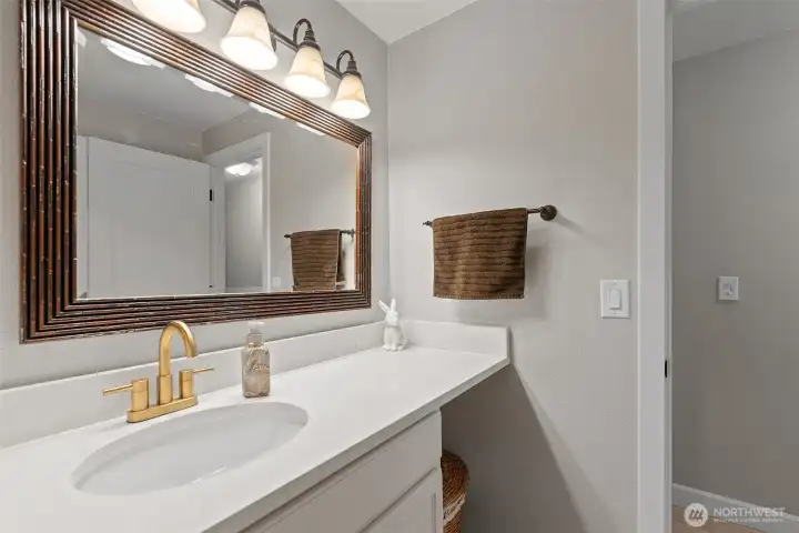 Main bathroom with gold faucet