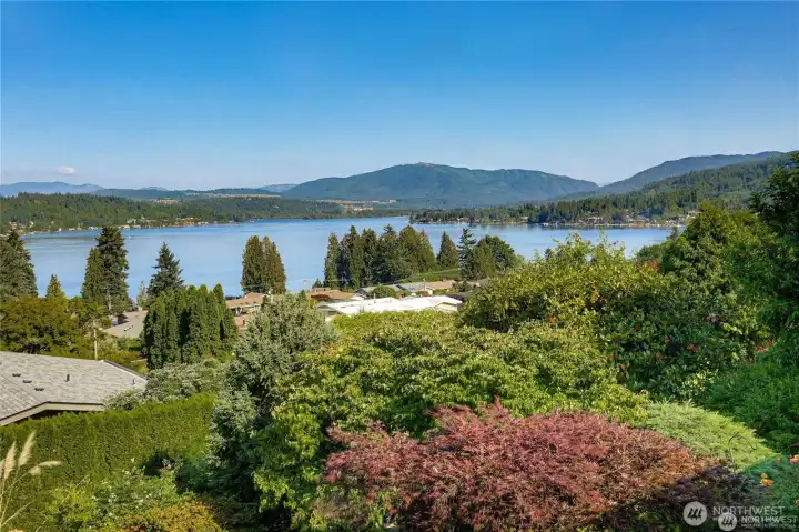 Panoramic Lake Sammamish and Cascade views framed by lush, mature landscaping for privacy and serenity.