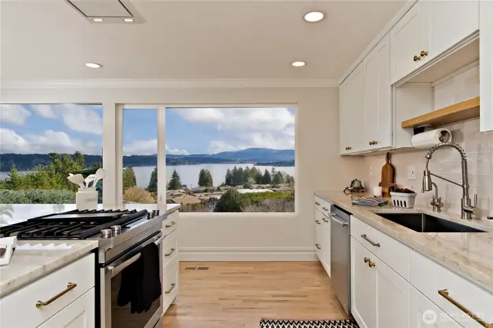 Custom cabinetry with pull-out drawers in the oversized island.