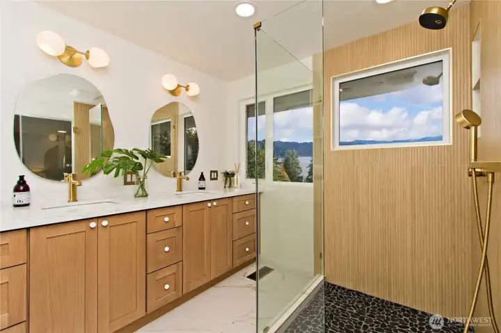 Spa-inspired, fully remodeled, primary bath with heated floors and mirrors.