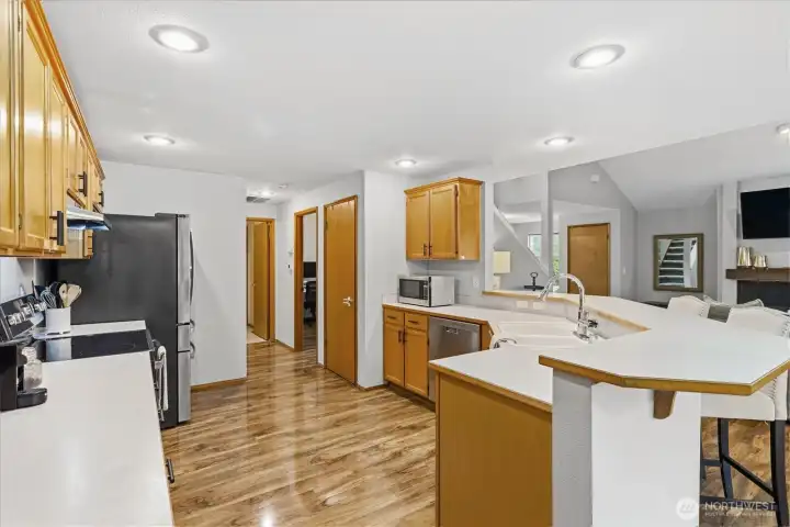 The kitchen offers a high bar with room for 4 chairs, stainless appliances and pantry space.