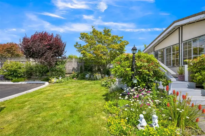 Front yard has cheery flower gardens