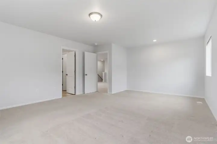 At the top of the stairs is an open and bright family/sitting room