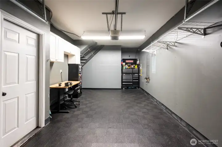 Garage with lock-in-tile flooring and direct entry to home.