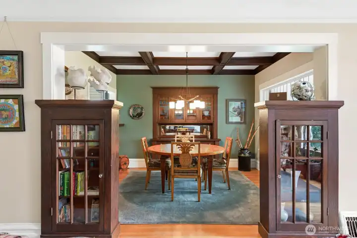 Dining room with box beamed ceilings and built in cabinets.