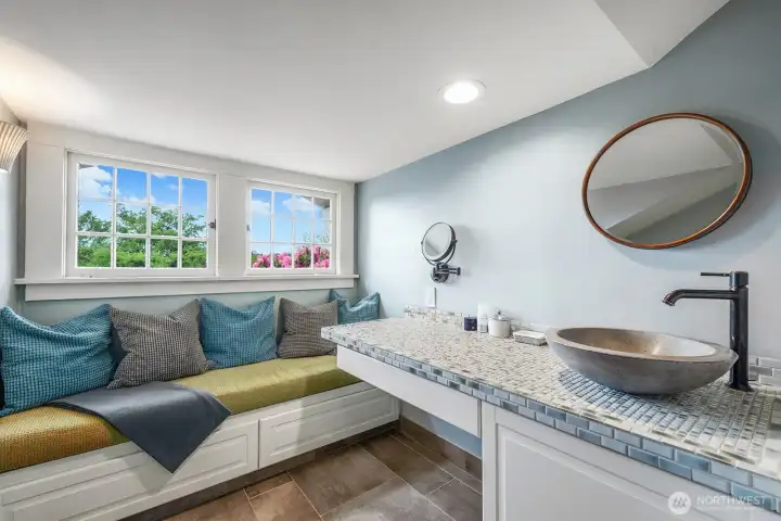Primary bathroom sink and sitting area.