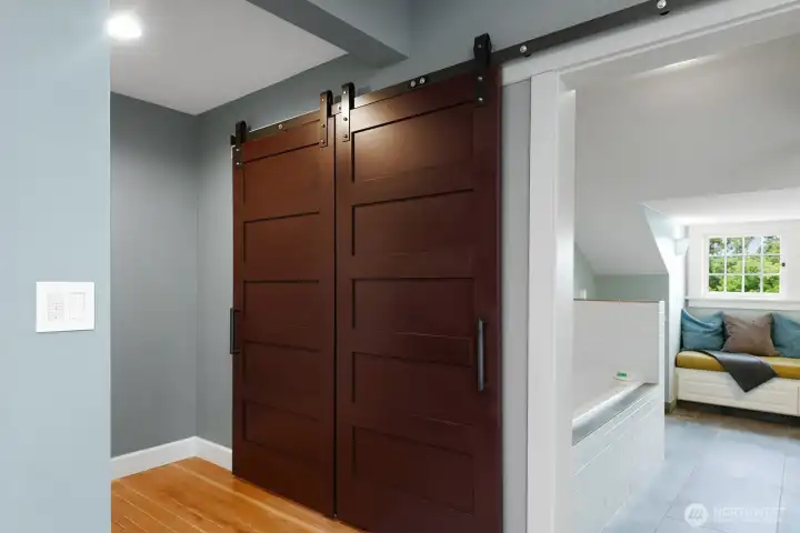 Walk-in closet in the primary suite is behind the barn doors.