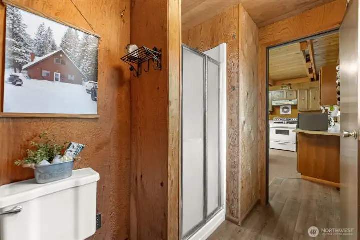 Functional bathroom layout with easy-access shower, durable flooring, and classic cabin-style wood interiors.