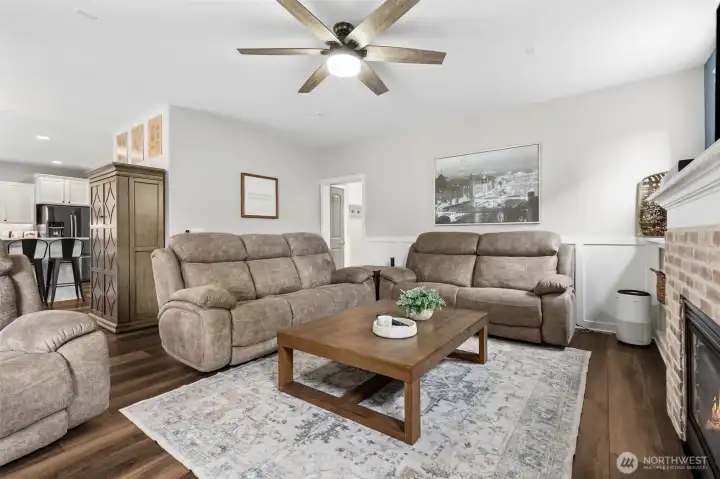Family room with fireplace opens to kitchen and view of the back yard space.