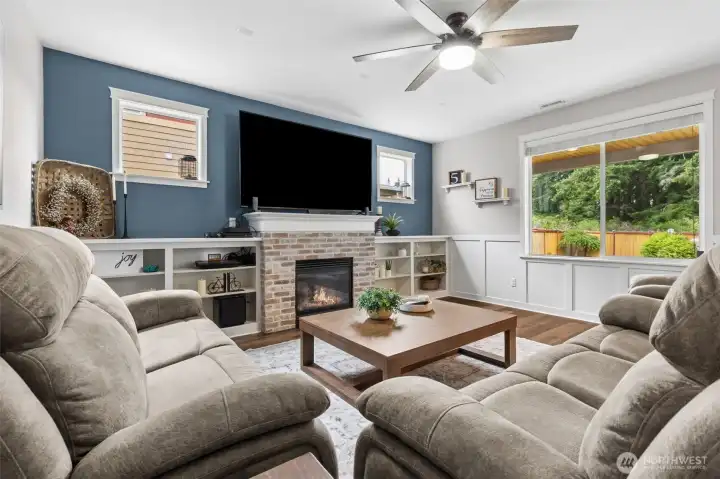 Family room with gas fireplace and custom built-in wall shelving.