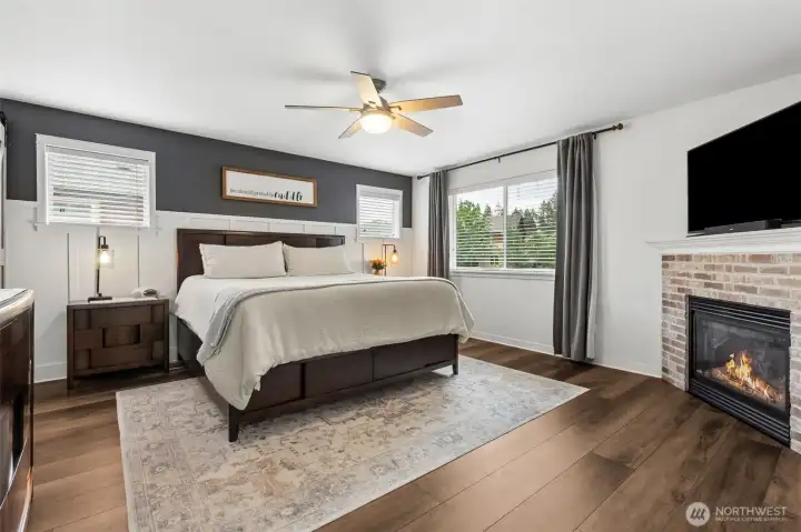 Primary suite with gas fireplace is open and bright has a walk in closing with built-in organizer and lovely luxury 5pc bath