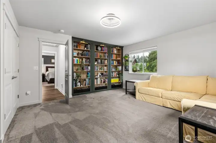 This upstairs bedroom is large! Has a built-in library with custom lighting. Wonderful space !