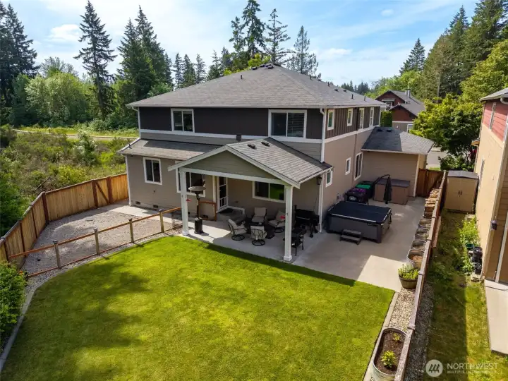 Large backyard with  covered patio, separate graveled dog run, hot tub!