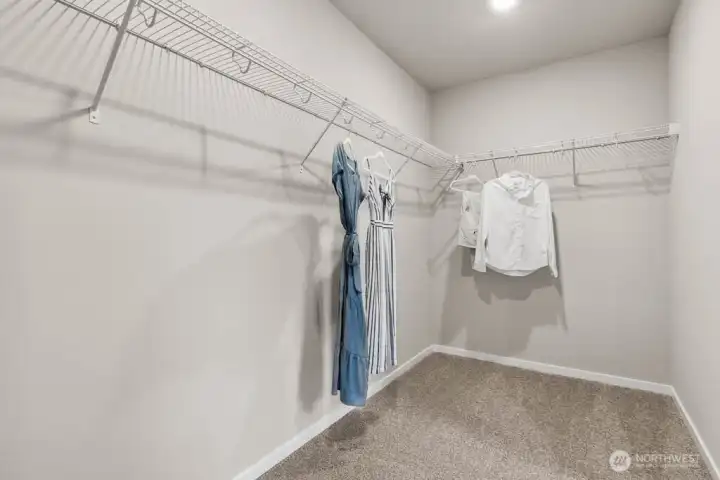Huge walk-in closet as part of the primary bedroom suite. Actual home is under construction. Colors, materials, and features may vary. See site agent for details. Huge walk-in closet as part of the primary bedroom suite. Actual home is under construction. Colors, materials, and features may vary. See site agent for details.