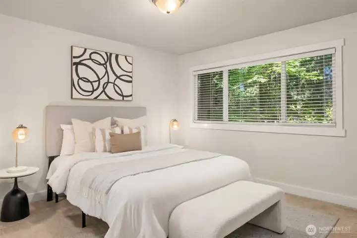 Upper level primary bedroom w/ walk in closet.