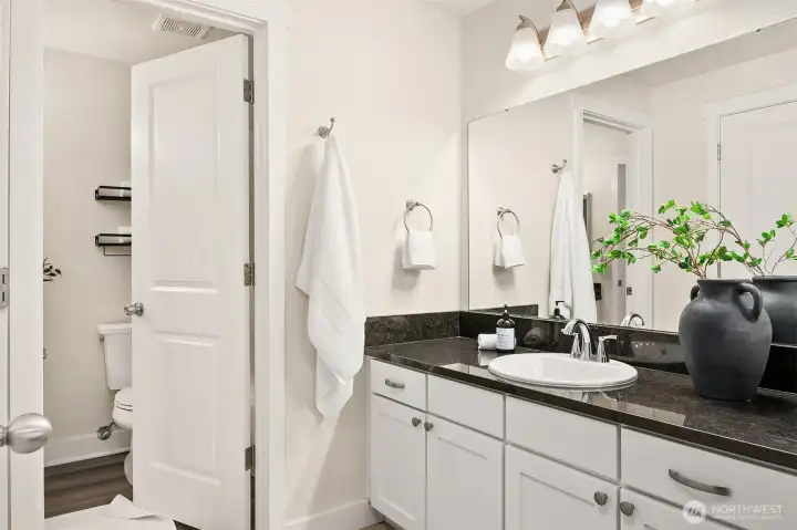 Sink area right off primary, opens to upper level full bathroom.