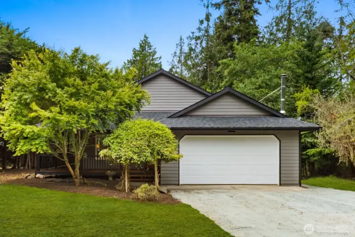 Craftsman-style curb appeal with a dark gray facade and white trim. Landscaping example. Lot has been cleaned and cleared. Craftsman-style curb appeal with a dark gray facade and white trim. Landscaping example. Lot has been cleaned and cleared.