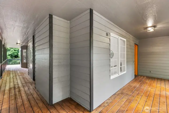 A charming covered walkway with a wood-plank ceiling and board-and-batten siding leads guests to the front door. A charming covered walkway with a wood-plank ceiling and board-and-batten siding leads guests to the front door.