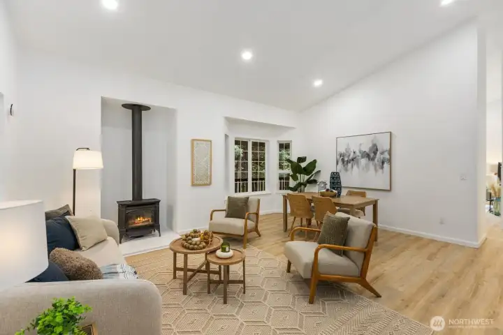 A cozy gathering space centered on a wood-burning stove, with French doors opening to the outdoors for abundant natural light. A cozy gathering space centered on a wood-burning stove, with French doors opening to the outdoors for abundant natural light.
