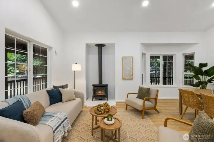 Vaulted ceilings amplify the sense of space in this inviting living area, anchored by a classic wood stove. Vaulted ceilings amplify the sense of space in this inviting living area, anchored by a classic wood stove.