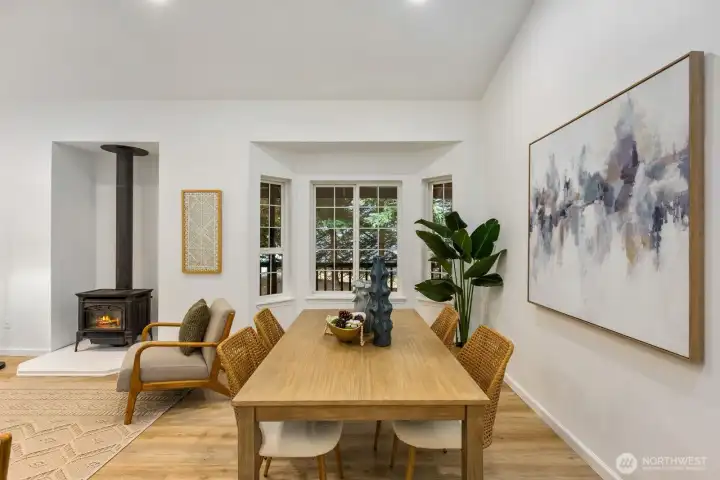 The open-concept living and dining area flows beneath vaulted ceilings, perfect for weekend entertaining. The open-concept living and dining area flows beneath vaulted ceilings, perfect for weekend entertaining.