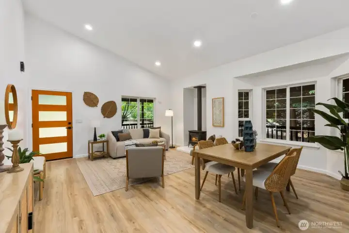 A wood-slat accent wall and warm finishes add character to this sunlit living and dining space. A wood-slat accent wall and warm finishes add character to this sunlit living and dining space.