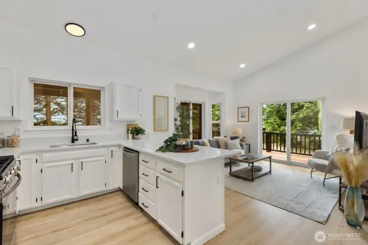 The open-concept design connects kitchen and living areas beneath vaulted ceilings, ideal for everyday living and entertaining. The open-concept design connects kitchen and living areas beneath vaulted ceilings, ideal for everyday living and entertaining.