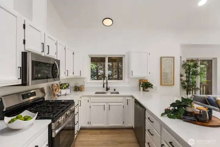 Crisp white cabinetry, tile backsplash, and stainless steel appliances lend a timeless, functional feel. Crisp white cabinetry, tile backsplash, and stainless steel appliances lend a timeless, functional feel.