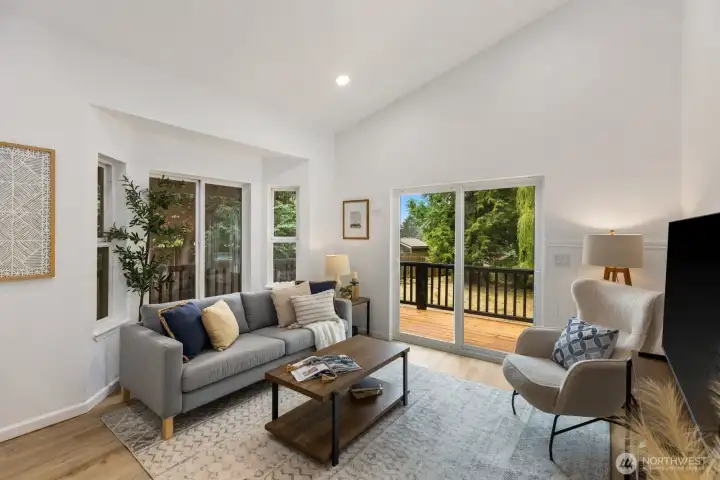 Sliding glass doors flood this vaulted living space with natural light and frame views of the backyard. Sliding glass doors flood this vaulted living space with natural light and frame views of the backyard.
