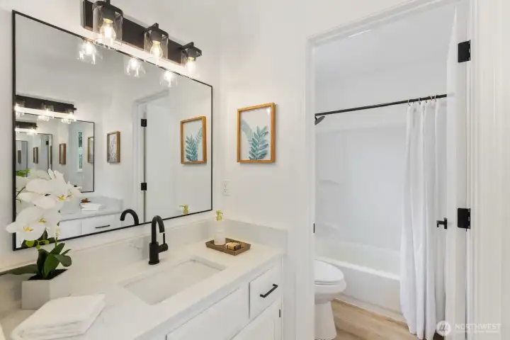 Sleek black fixtures and a dual vanity lend a modern, spa-like feel. Sleek black fixtures and a dual vanity lend a modern, spa-like feel.