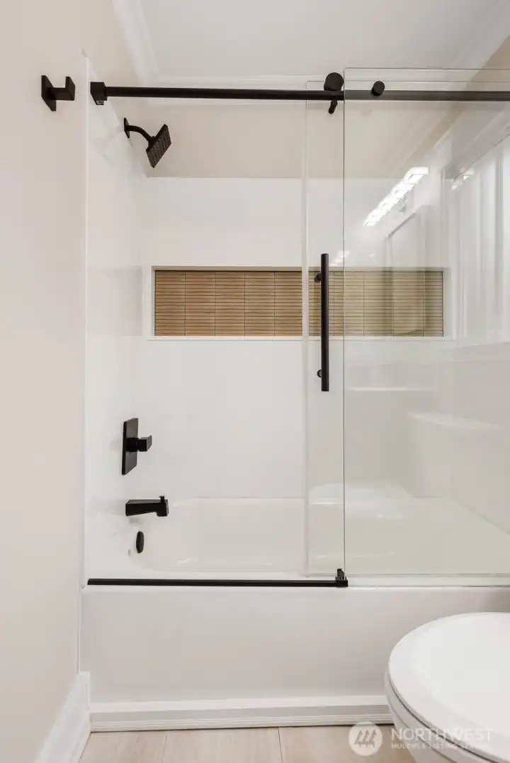Custom tile surround and frameless glass tub enclosure Custom tile surround and frameless glass tub enclosure