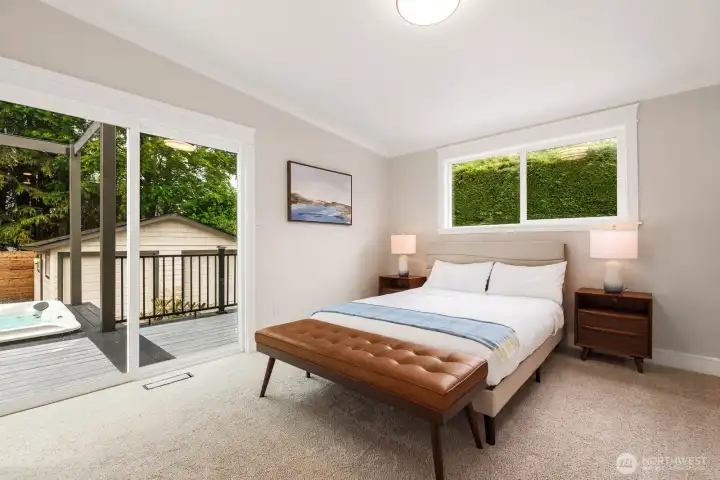 Primary suite with sliding door to the large deck and backyard/hot tub Primary suite with sliding door to the large deck and backyard/hot tub