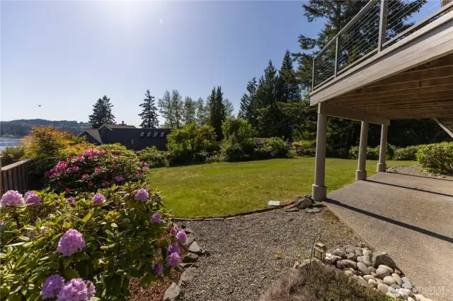 Lush landscaping in the mostly fenced backyard