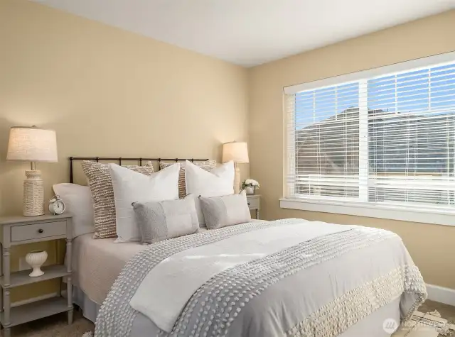 This generous guest bedroom on the upper level is flooded with natural light.