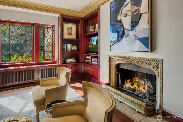 This is one of 4 gas fireplaces on the main floor. Love that original stone surround.