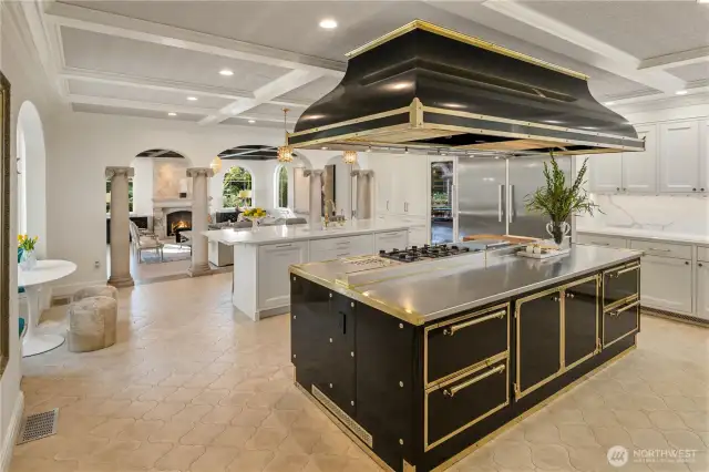 This is a first for me. I have never seen a Officine Gullo cooking island & commercial grade hood: 4 burners, induction station, griddle station, pasta/steamer station, prep area, convection oven, gas oven & warming area with 2 levels! Like a big lovely piece of jewelry for your kitchen! Also in the kitchen, an island for watching the cooking/TV while eating with room for 6 stools. Two Miele dishwashers, and a full size Miele refrigerator & freezer, 2 sinks, curved breakfast nook & so much more! Notice the adjoining family room through the archways....