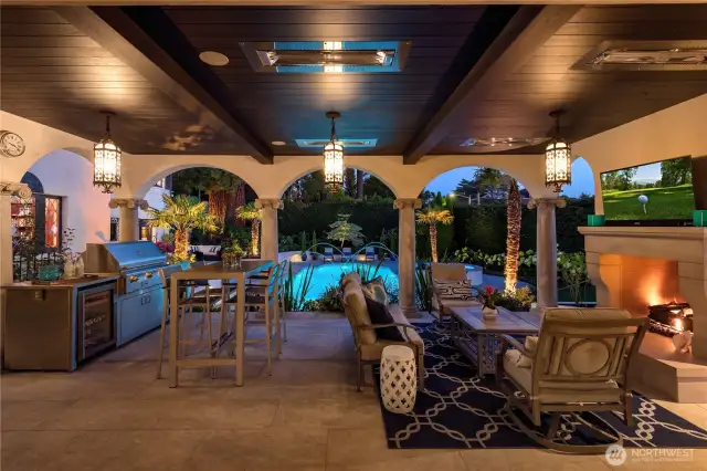 Right outside of the main-floor family room is a wonderful outdoor covered patio complete with a gas fireplace, TV, BBQ, beverage fridge and more. Those colums frame the view to teh pool so beautifully!