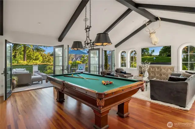 Now up to the second story. Over the family room is a bonus room with 3 sets of French doors that open to yet another outdoor terrace. Simply too much! A vaulted & beamed ceiling adds volume.