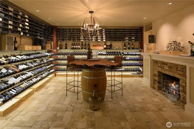 Behind a 300lb door with ornate ironwork and glass (& secured by a boimetric lock)...your 1250 bottle capacity awaits! There is a racking system to ensure that every bottle's label can be seen, including low power LED lights shining sown on the bottles. Venetian plaster walls and a travertine tile floor.