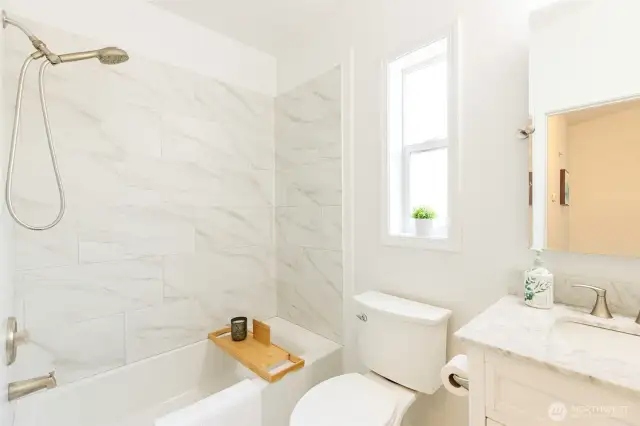 Secondary bathroom with bright tile surround