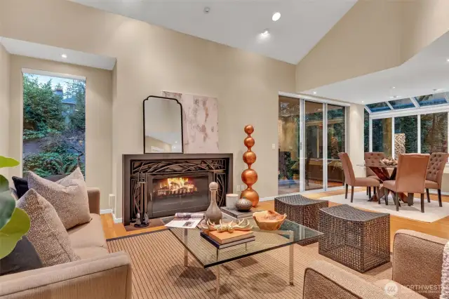 Great room with living and dining spaces, anchored by custom, wood-burning fireplace - plumbed for gas!