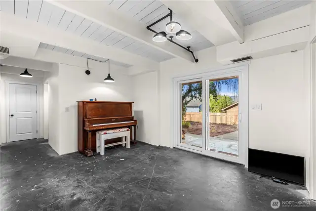 Open space in lower level leading to western patio and pergola