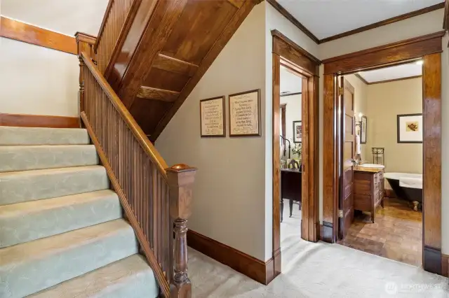 Stairs to the third floor, under stair nook, first bedroom on the left, 3/4 bath, second bedroom on the right.