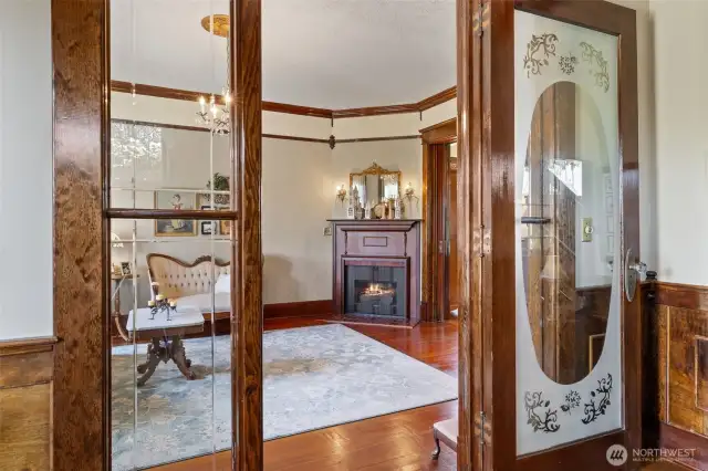 Formal entry into the living room with gas fireplace and windows looking out to the front garden.