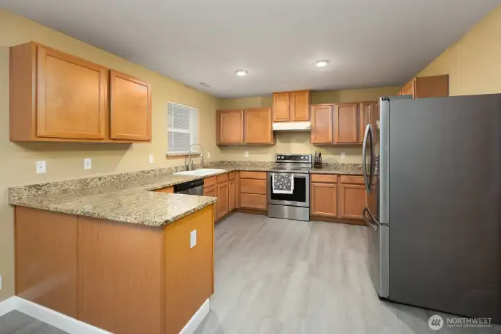 Gatherings and entertaining will happen is this spacious kitchen with beautiful granite countertops