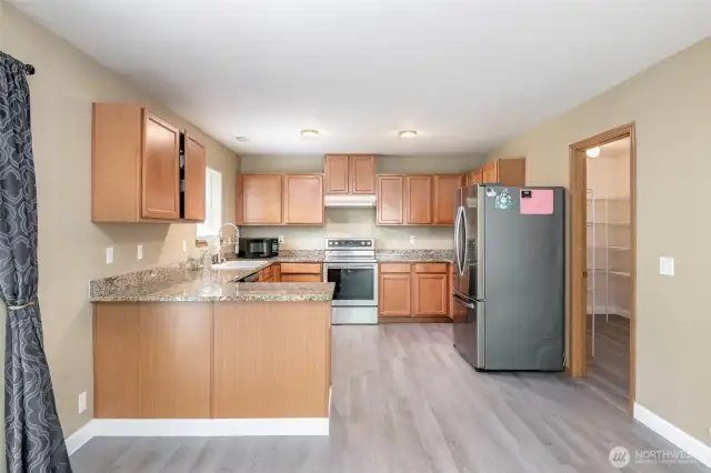 Kitchen with granite counter tops and all appliances stay with home.