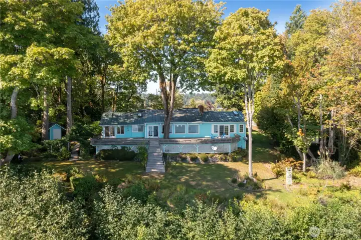 Well kept yard surrounded by old growth trees