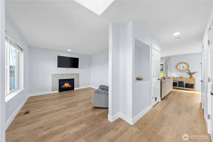 Entry leads to front room, hall to living room, and powder room.